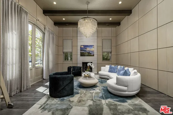 a living room with furniture and a chandelier