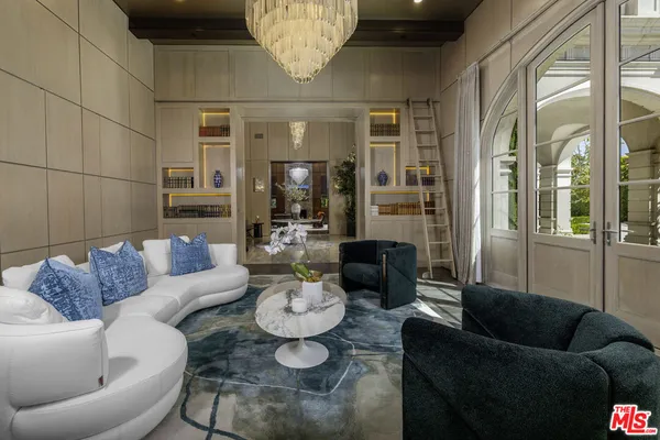 a living room with furniture and a glass door
