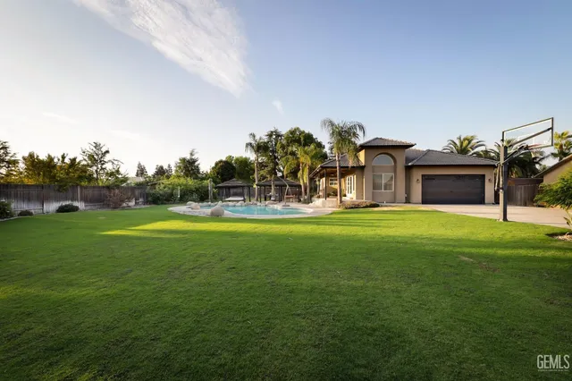 a house view with swimming pool in front of it