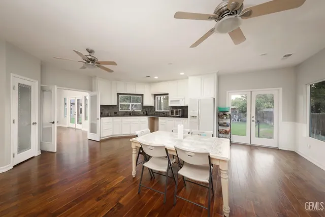 a view of a dining room and livingroom with furniture wooden floor