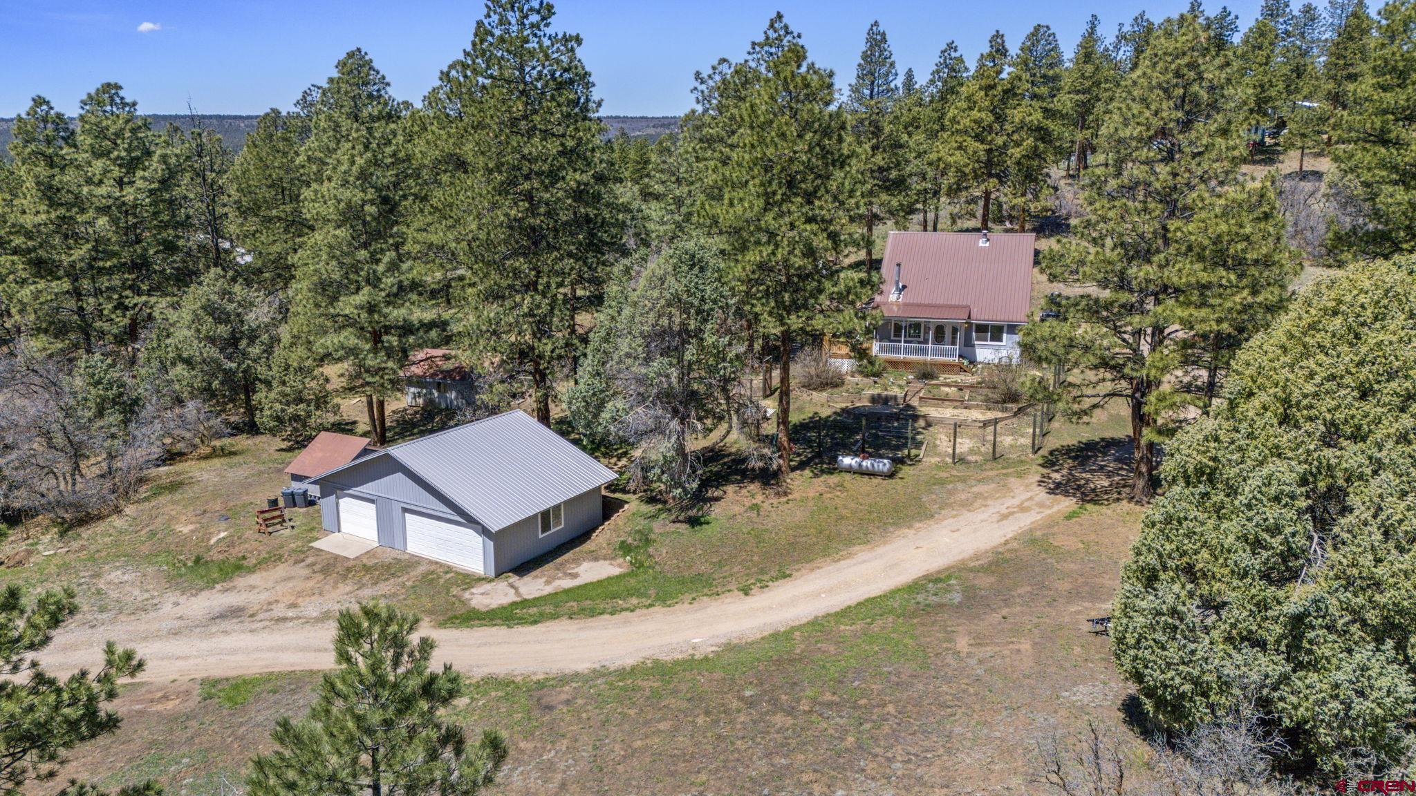 145 N Road Durango, CO 81303 - Photo 1 of 35 an aerial view of a house with a yard and lake view