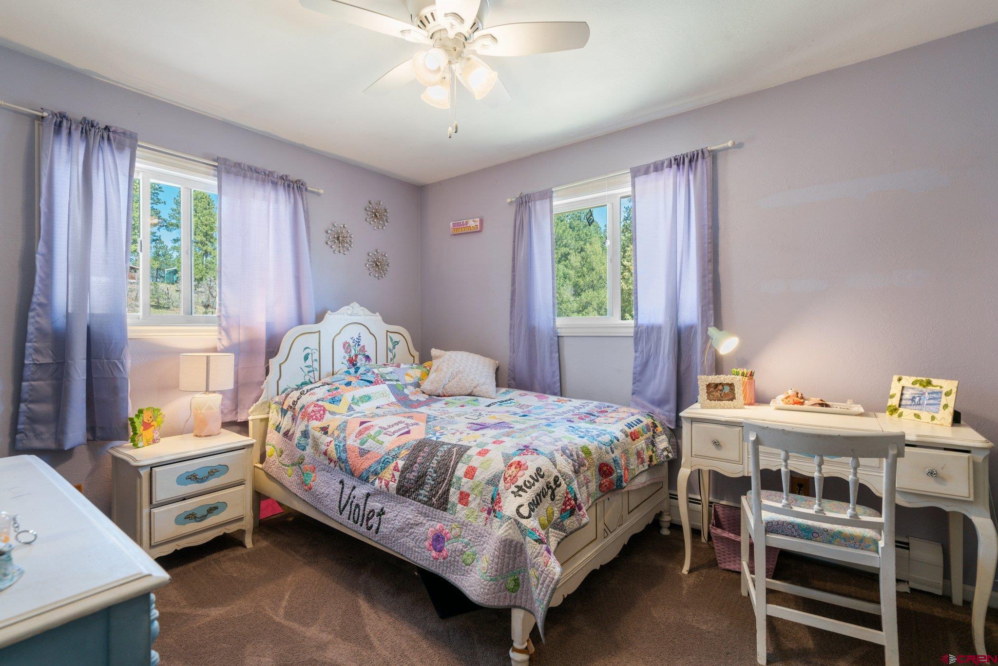 145 N Road Durango, CO 81303 - Photo 22 of 35 a bedroom with a bed and a chandelier