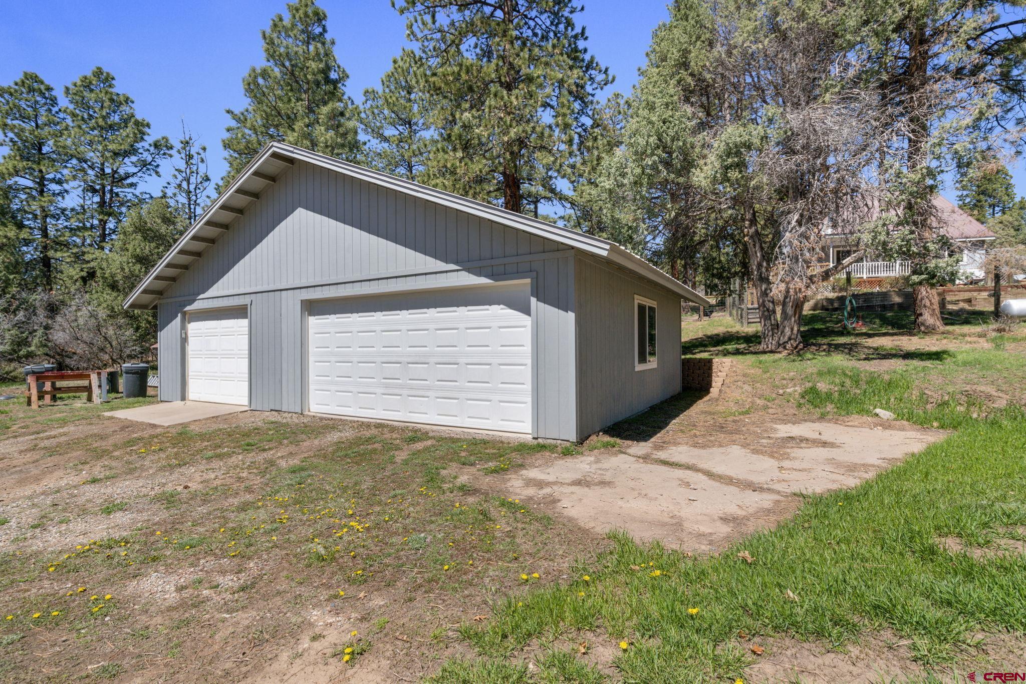 145 N Road Durango, CO 81303 - Photo 26 of 35 a backyard of a house with large trees and brick walls