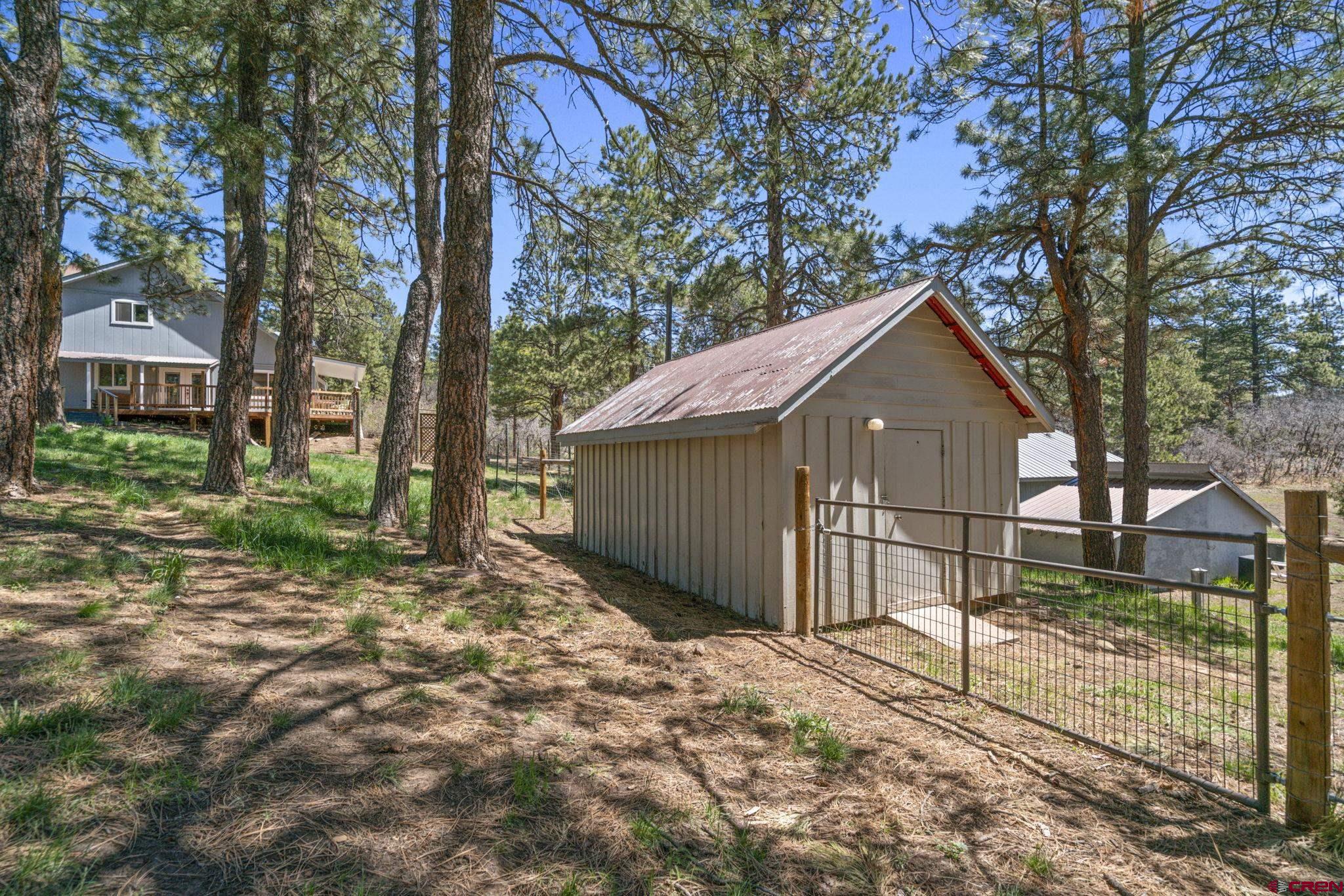 145 N Road Durango, CO 81303 - Photo 28 of 35 a view of a house with a yard and large tree