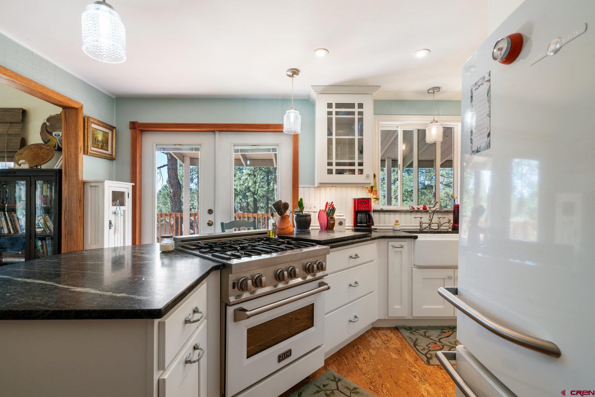 145 N Road Durango, CO 81303 - Photo 3 of 35 a kitchen with stainless steel appliances granite countertop a stove a sink and a refrigerator