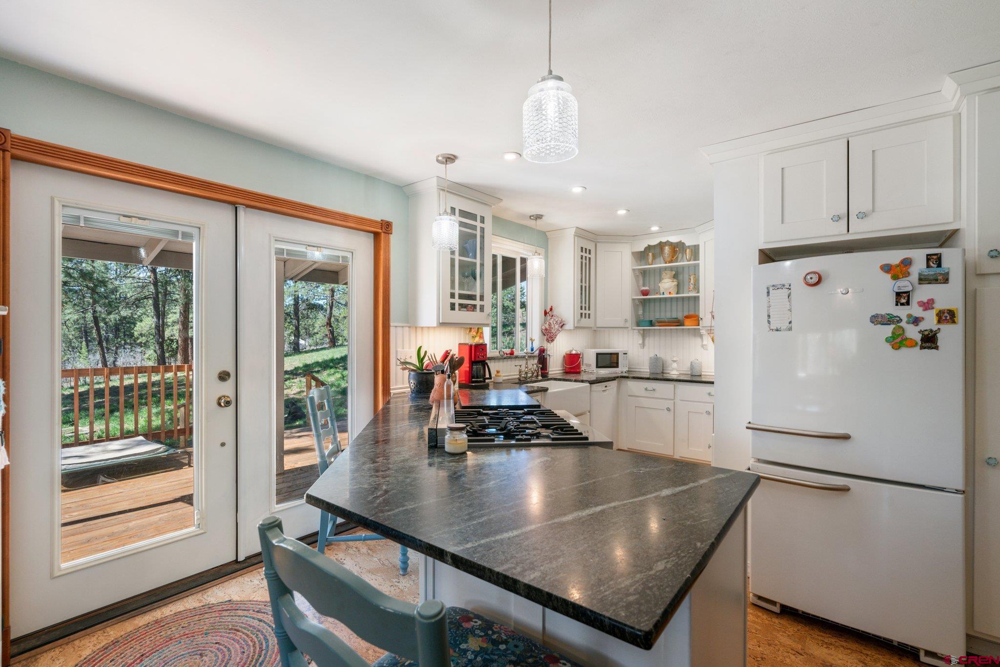 145 N Road Durango, CO 81303 - Photo 8 of 35 a kitchen with stainless steel appliances granite countertop a sink a refrigerator and a stove