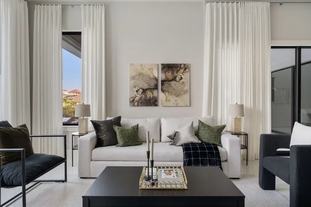 a bed sitting in a bedroom next to a window with potted plant