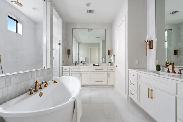 a bathroom with a granite countertop sink toilet mirror and shower