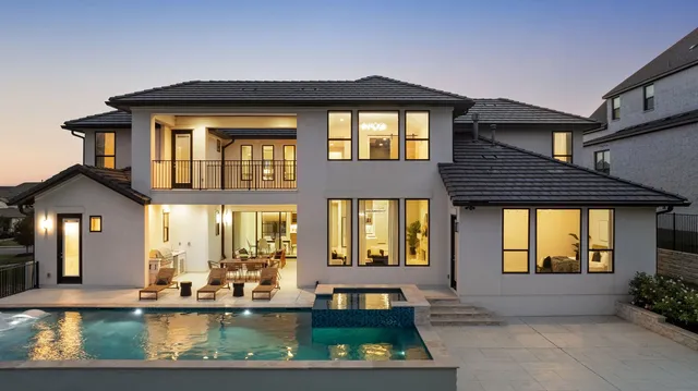 a front view of a house with swimming pool and porch