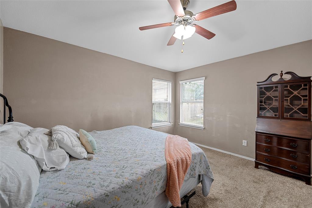 6725 Cold Water Drive Waco, TX 76712 - Photo 8 of 19 a bedroom with a bed a chandelier and a dresser