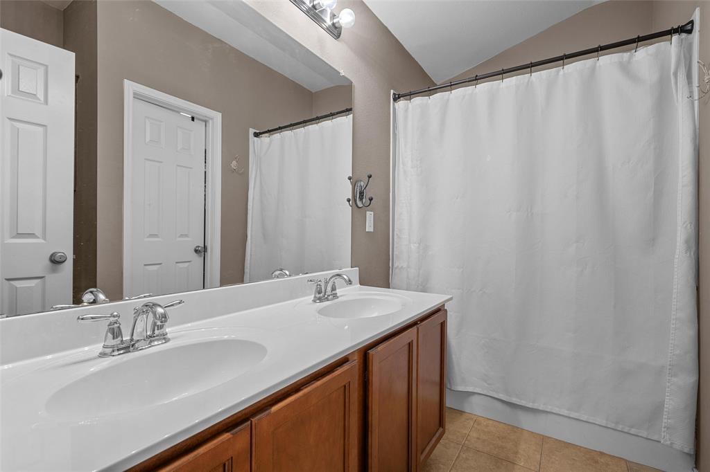 6725 Cold Water Drive Waco, TX 76712 - Photo 9 of 19 a bathroom with a double vanity sink and a mirror