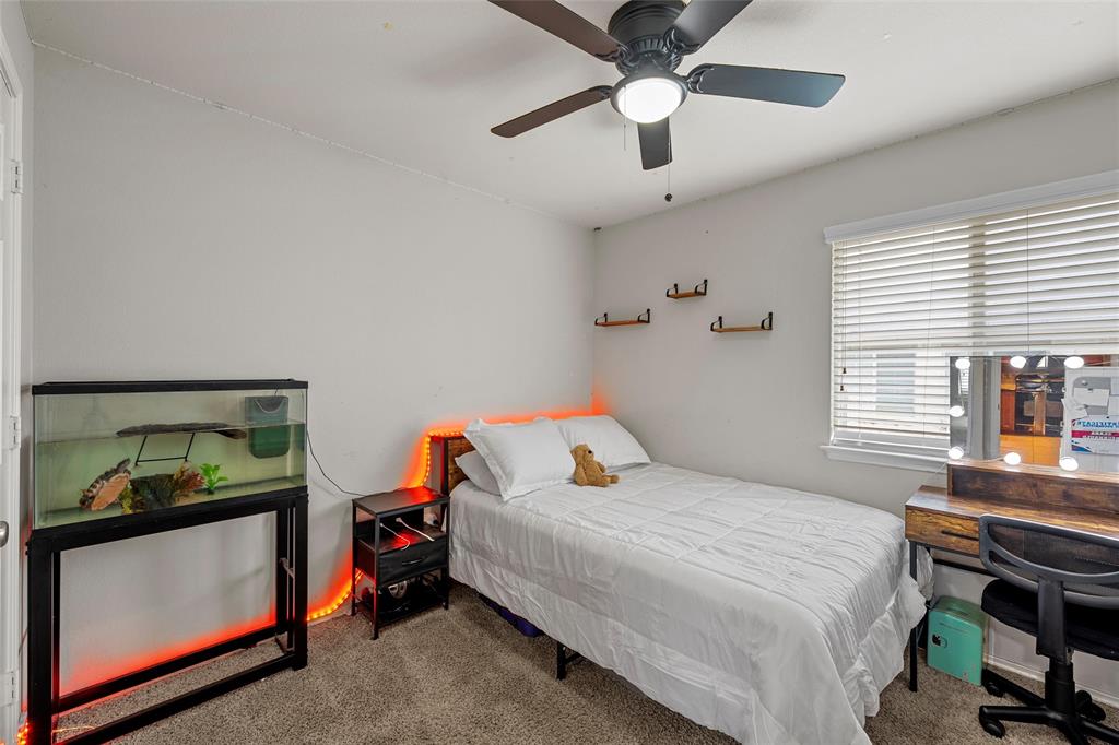 6725 Cold Water Drive Waco, TX 76712 - Photo 10 of 19 a bedroom with a bed and a chandelier