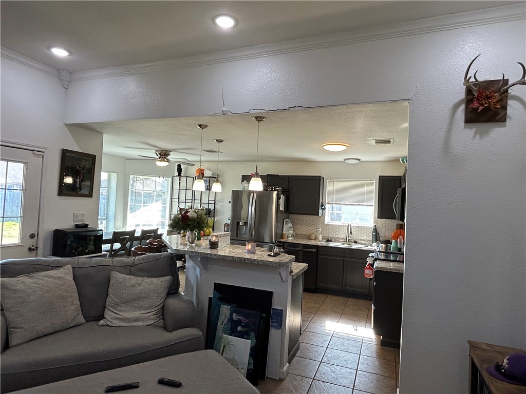 220 Knight Lane Waco, TX 76705 - Photo 8 of 11 a living room with stainless steel appliances kitchen island granite countertop furniture and a view of kitchen