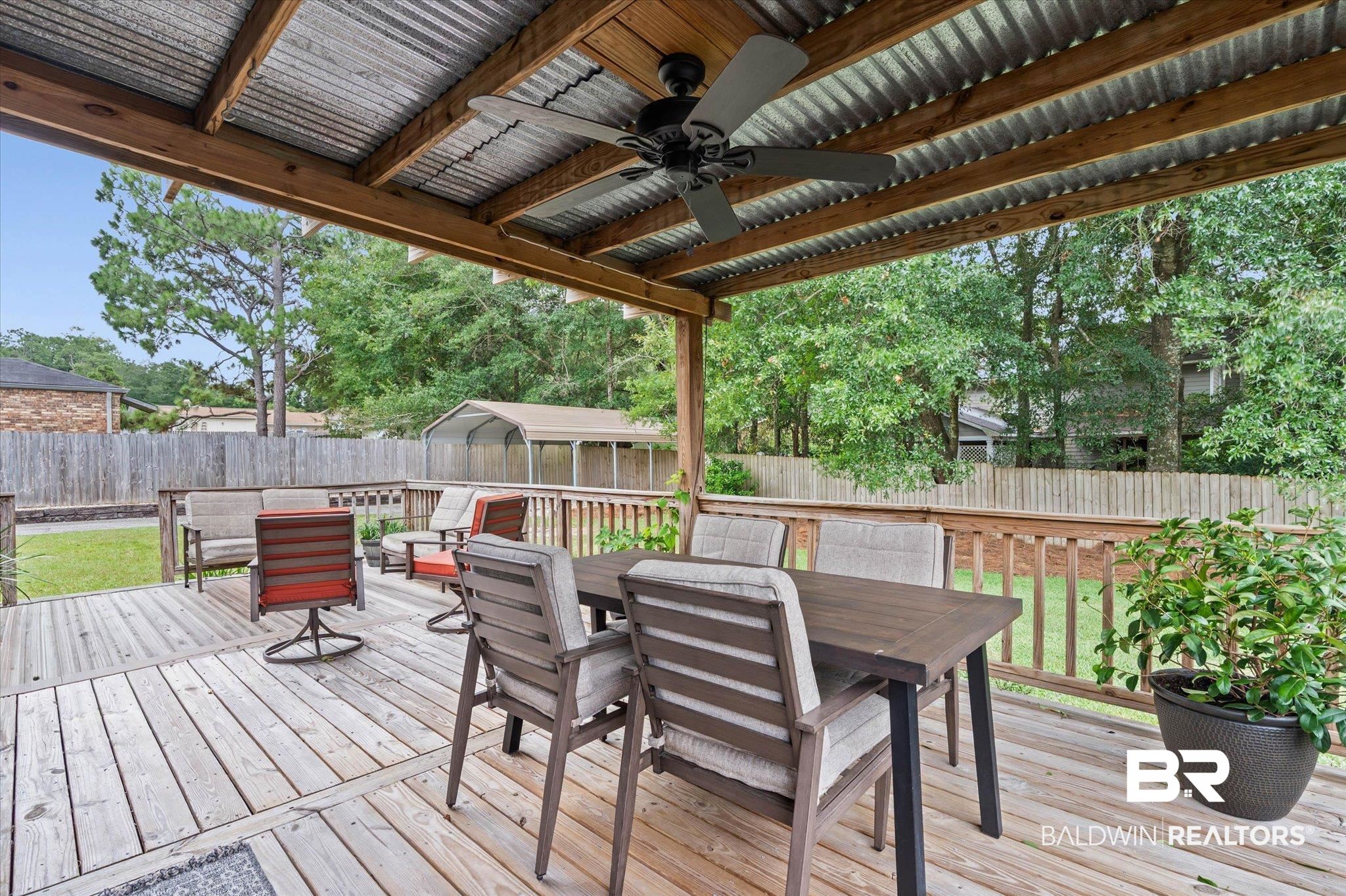 6501 Gas Light Lane South Mobile, AL 36695 - Photo 18 of 23 Covered outdoor deck featuring a corrugated metal roof, wood ceiling, and a ceiling fan