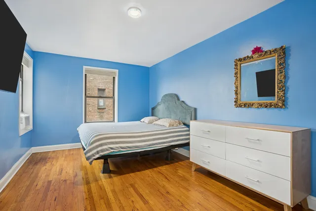 a living room with furniture a flat screen tv and a floor to ceiling window