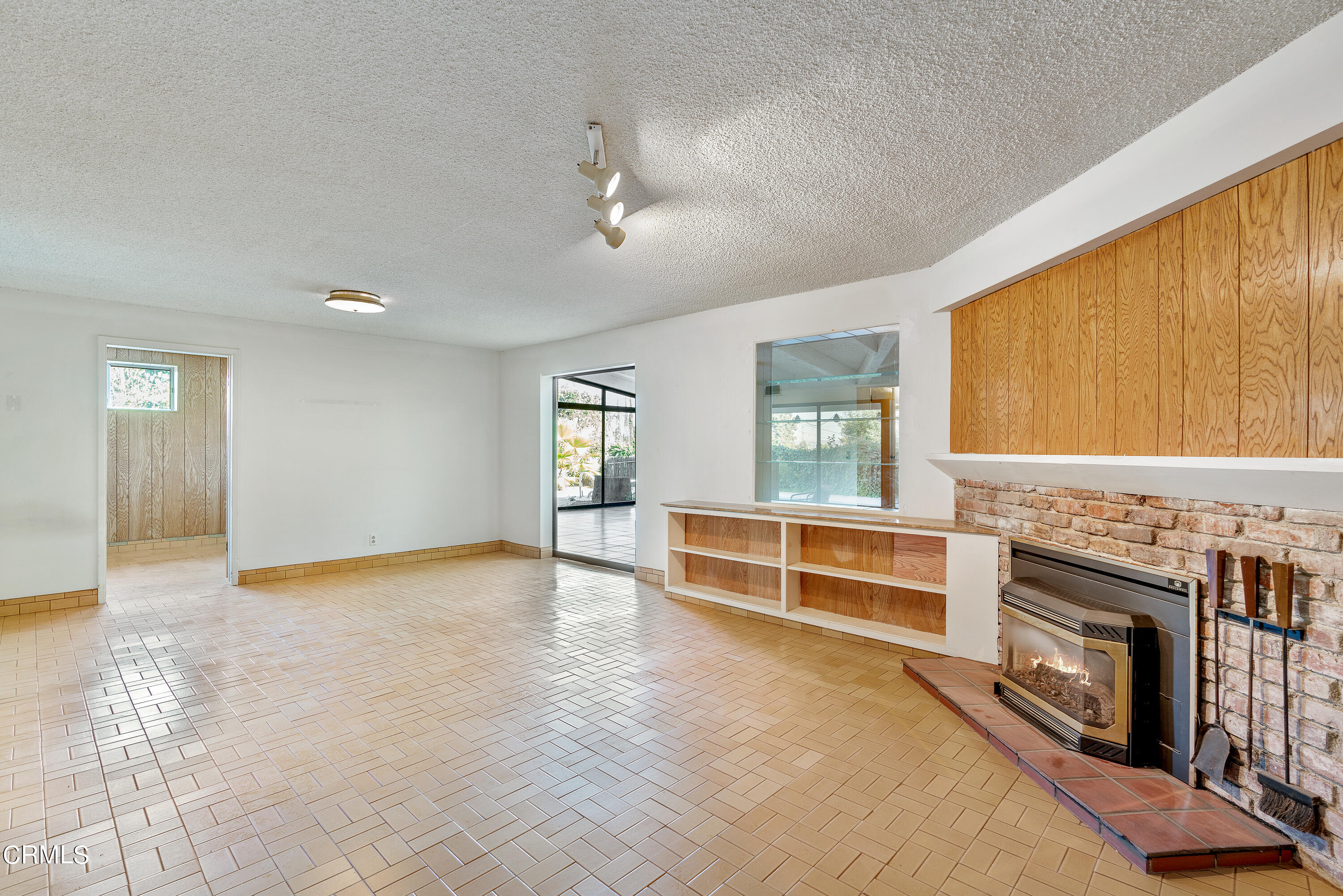 646 Spring Point Drive Bradbury, CA 91008 - Photo 15 of 26 a view of an empty room with a fireplace and a window