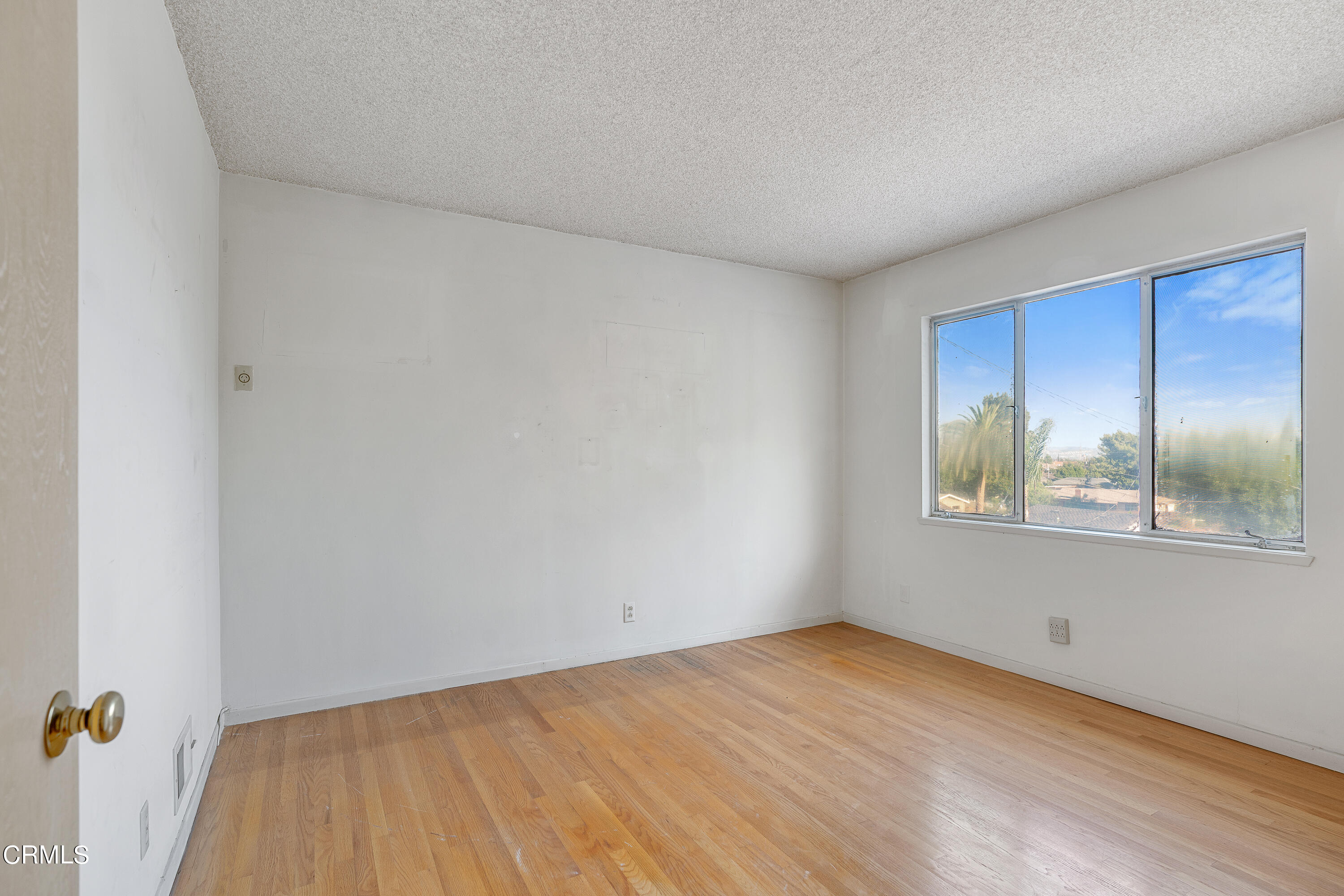 646 Spring Point Drive Bradbury, CA 91008 - Photo 19 of 26 a view of an empty room with window and wooden floor