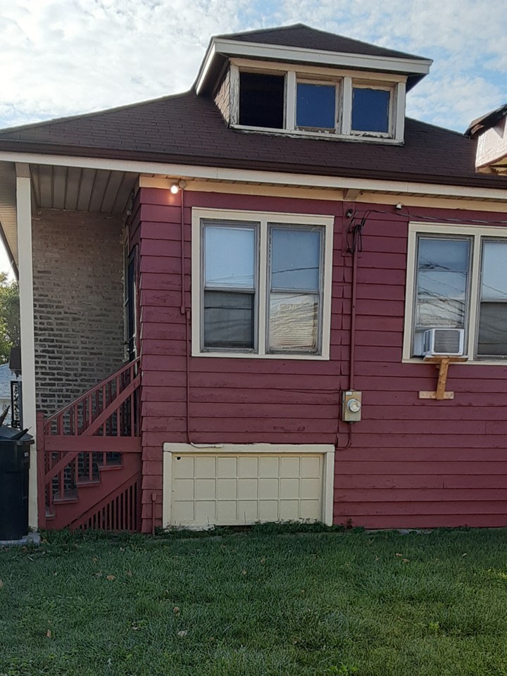 Undisclosed Address Chicago, IL 60620 - Photo 15 of 16 a front view of a house with a yard