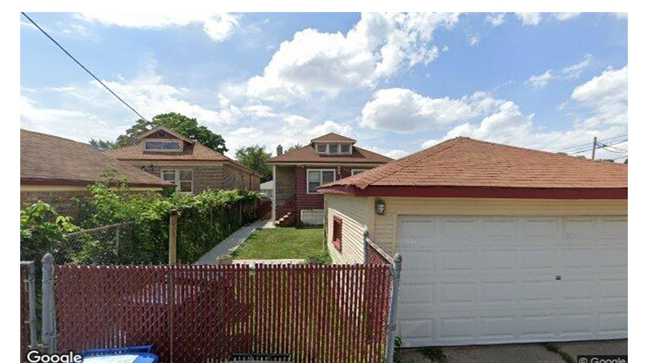 Undisclosed Address Chicago, IL 60620 - Photo 16 of 16 a view of a house with wooden fence