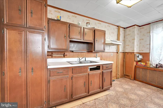 a utility room with stainless steel appliances a refrigerator and a stove