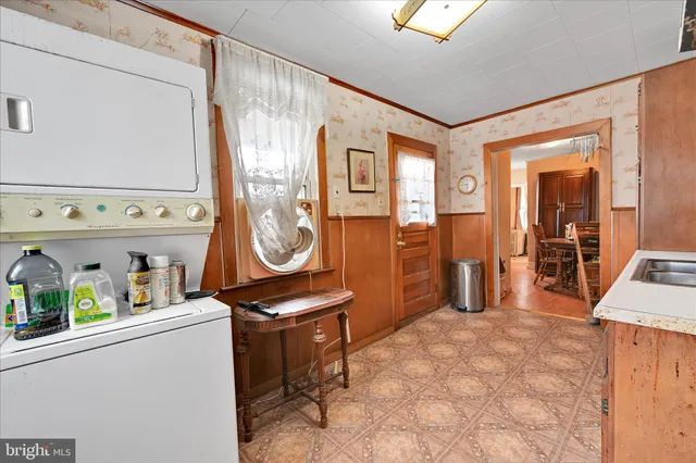 a kitchen with stainless steel appliances granite countertop a refrigerator a sink dishwasher and wooden cabinets with wooden floor