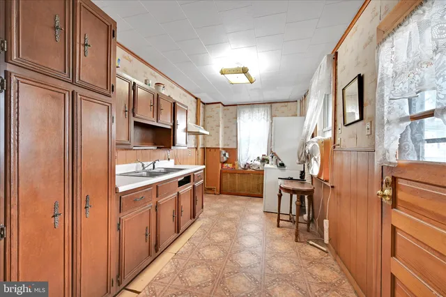 a bedroom with furniture and a large window