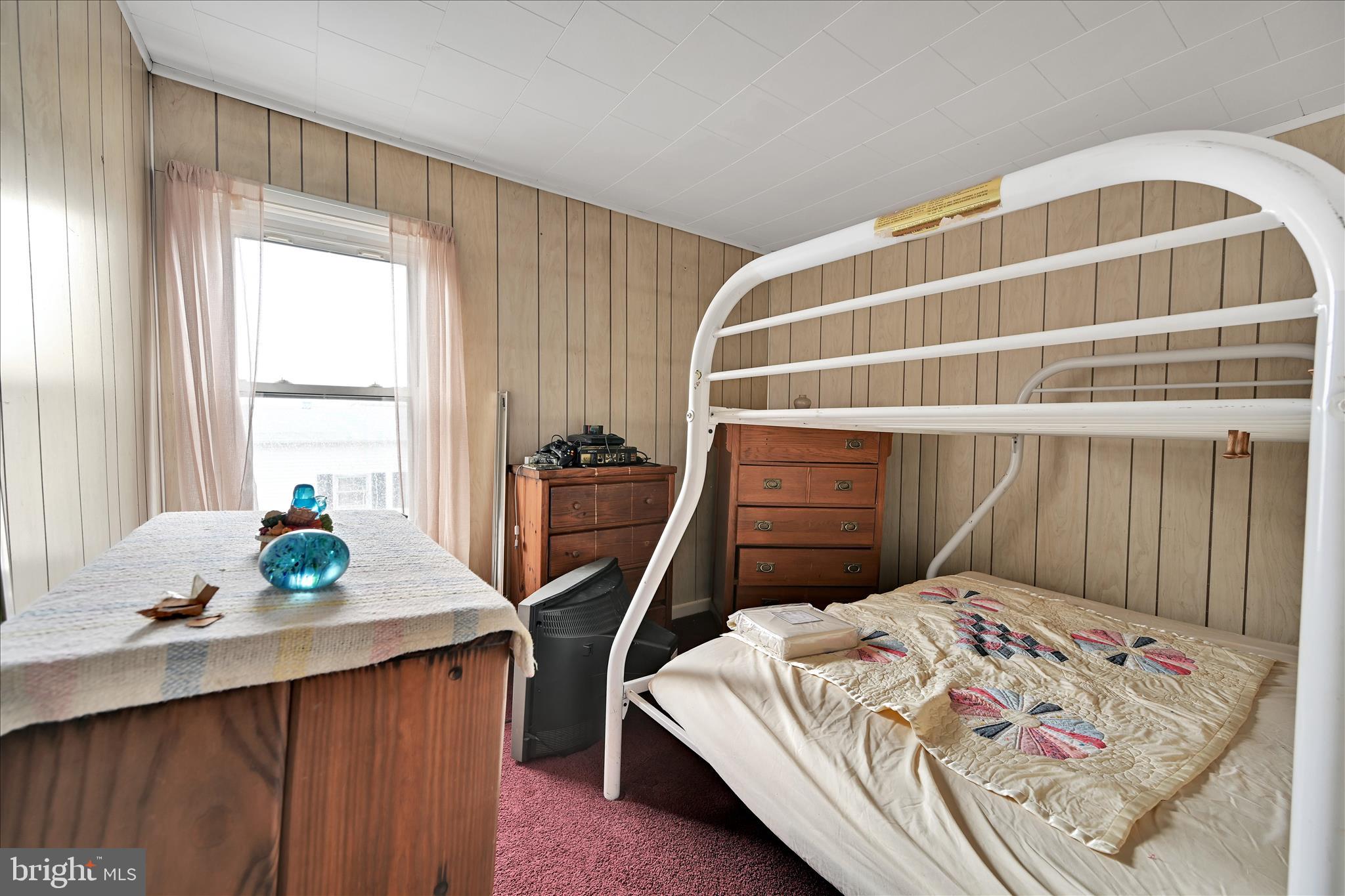 1501 Centre Street Ashland, PA 17921 - Photo 18 of 29 a bedroom with a bed a dresser and a window