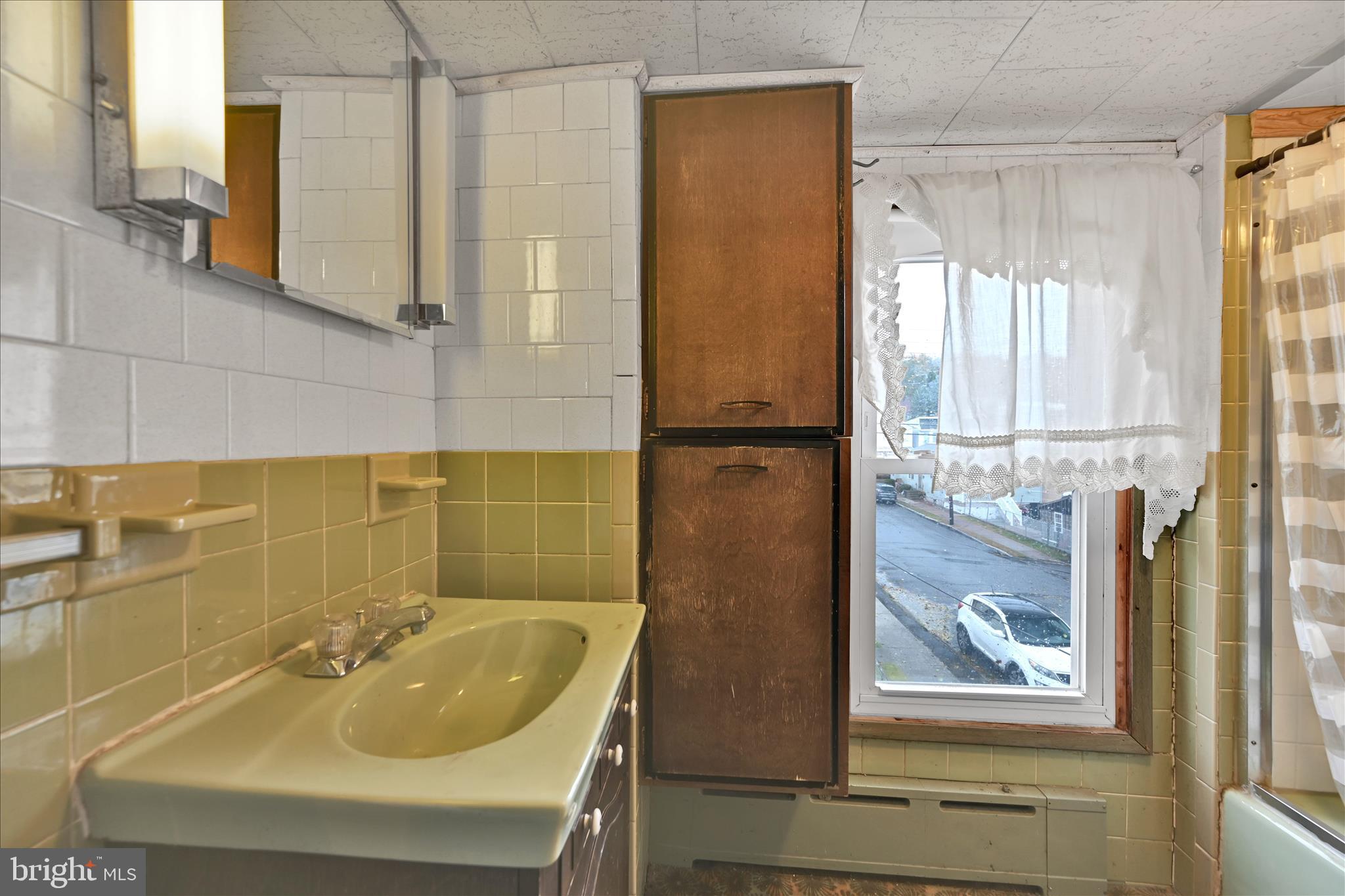 1501 Centre Street Ashland, PA 17921 - Photo 22 of 29 a bathroom with a sink and mirror with bathtub