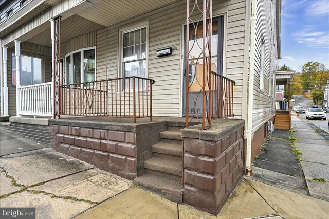 a view of a patio with couches chairs and wooden floor