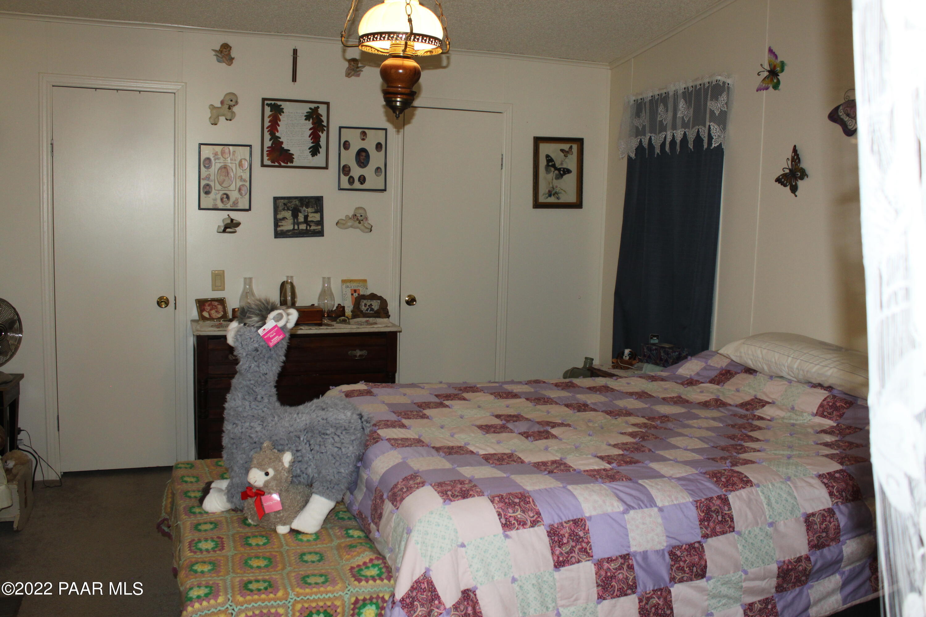 1740 West Big Sky Ranch Road Paulden, AZ 86334 - Photo 3 of 25 a bedroom with a bed and a dresser