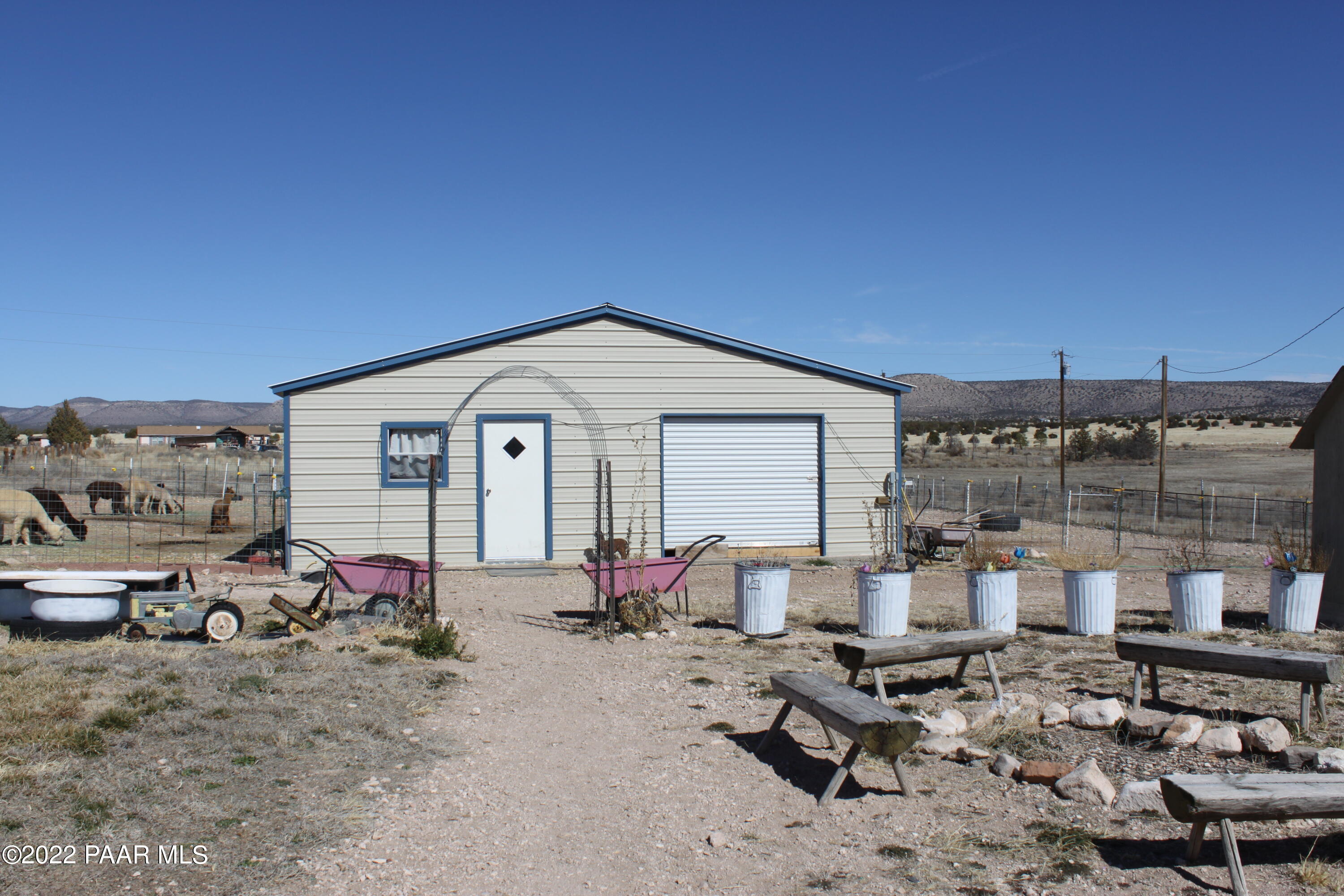1740 West Big Sky Ranch Road Paulden, AZ 86334 - Photo 9 of 25 a view of a backyard with table and chairs potted plants