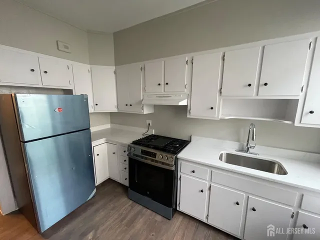 a kitchen with cabinets appliances and a sink