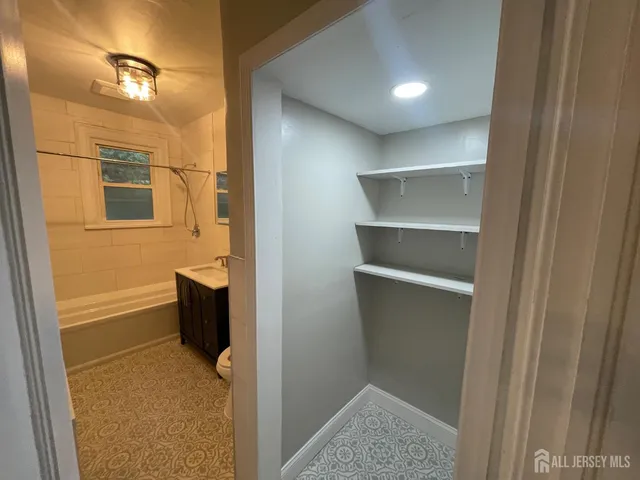 a bathroom with a tub and shower