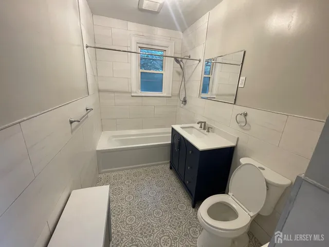a bathroom with a bathtub sink and toilet