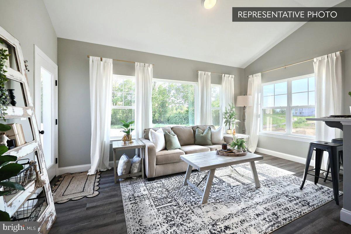 Copper Beech Plan At Seiders Hill Pottsville, PA 17901 - Photo 12 of 19 a living room with furniture and a flat screen tv