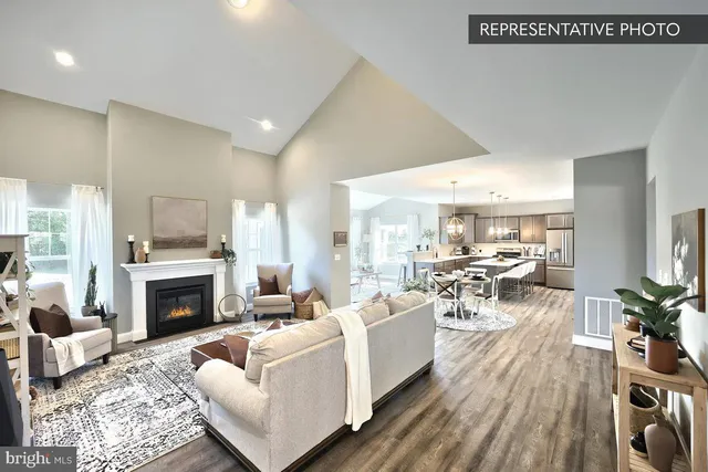 a living room with furniture a fireplace and a table