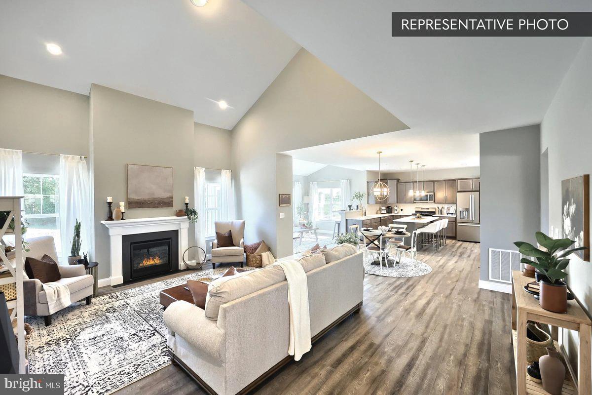 Copper Beech Plan At Seiders Hill Pottsville, PA 17901 - Photo 13 of 19 a living room with furniture a fireplace and a table