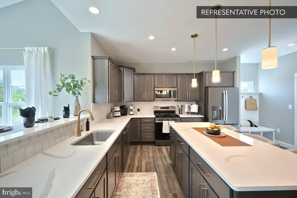 Copper Beech Plan At Seiders Hill Pottsville, PA 17901 - Photo 8 of 19 a kitchen with counter top space a sink and appliances
