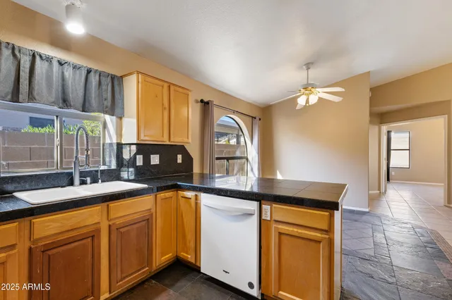 a view of a livingroom with a ceiling fan and window