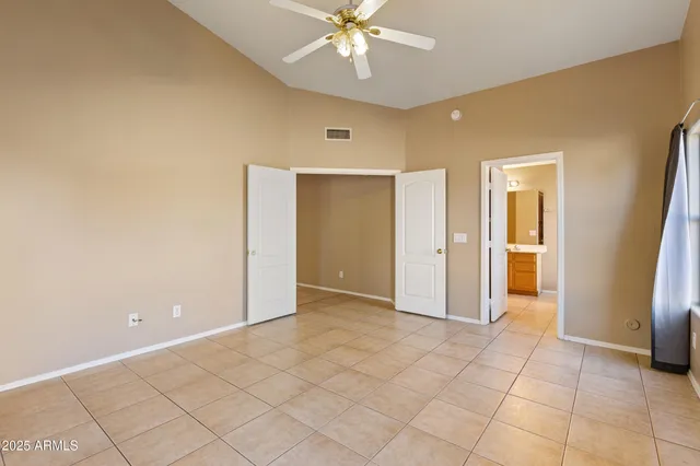 a spacious bathroom with a double vanity sink large mirror and a bathtub