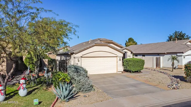 a view of a house with a small yard and potted plants