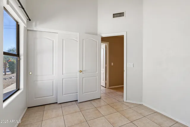 a view of a livingroom with an empty space and a window