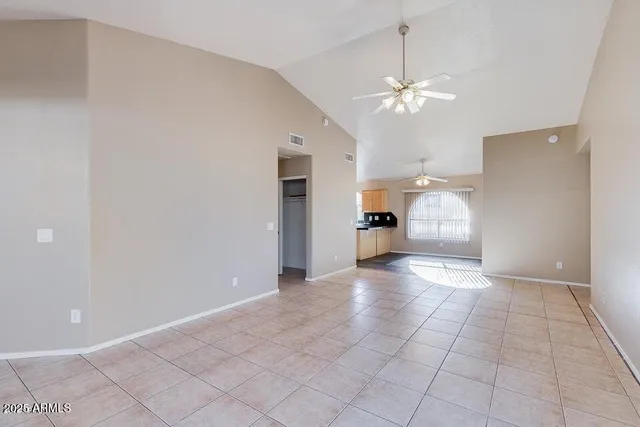 a view of a livingroom with a chandelier fan and hardwood floor