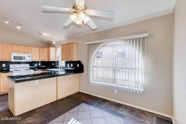 a kitchen with stainless steel appliances granite countertop a sink and a stove
