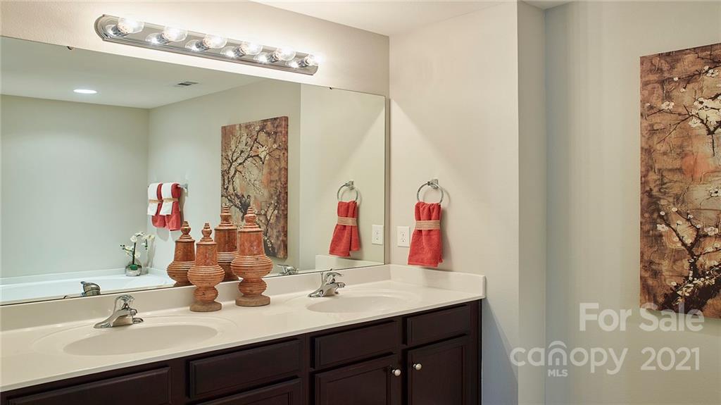 404 Misty Law Lane Clover, SC 29710 - Photo 39 of 48 a bathroom with a sink vanity and a mirror