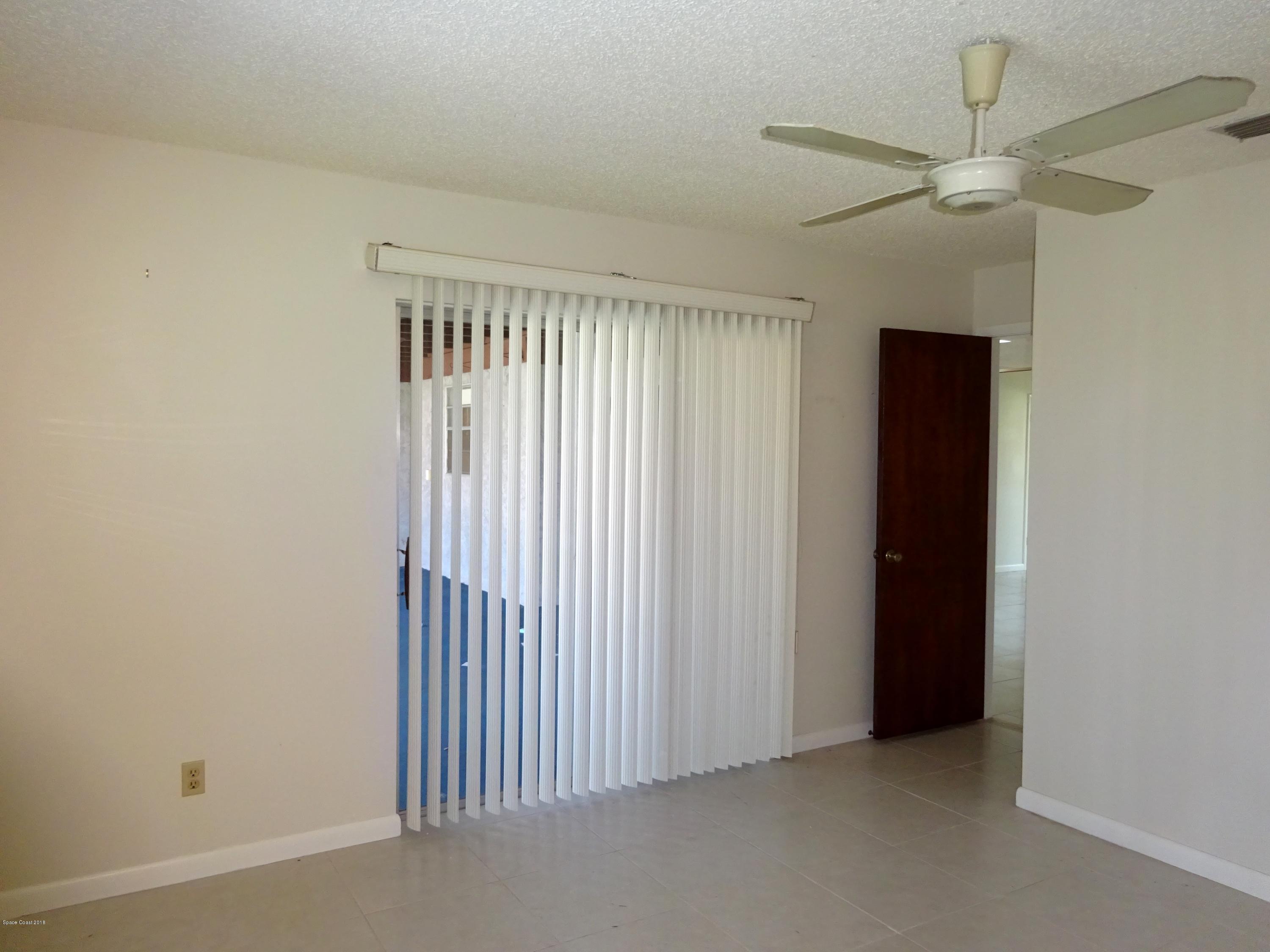 2020 Tallridge Road Melbourne, FL 32935 - Photo 19 of 31 Bedroom 2 with Sliders to Porch