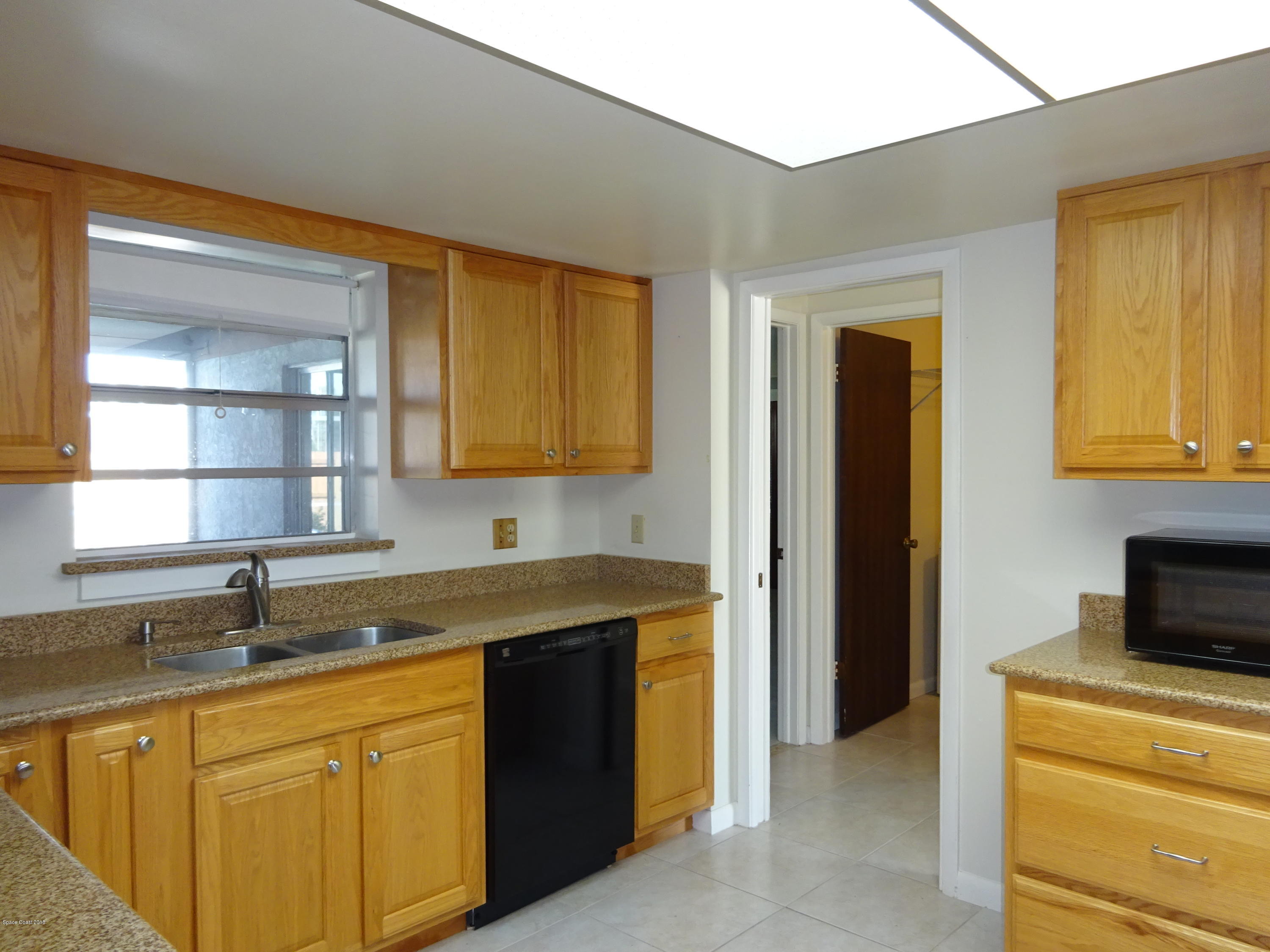 2020 Tallridge Road Melbourne, FL 32935 - Photo 6 of 31 Kitchen to Laundry & Master Bedroom