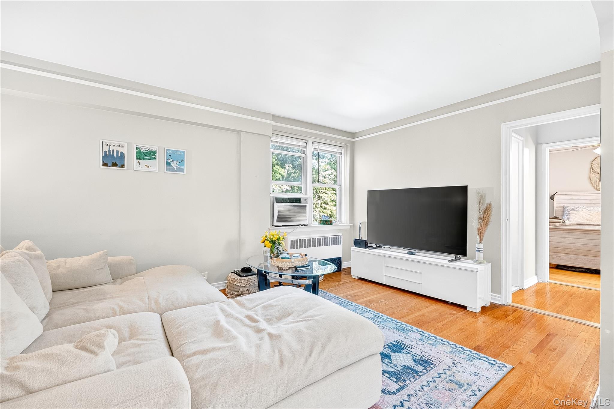 821 Bronx River Road, Unit 5J Bronxville, NY 10708 - Photo 17 of 30 a bedroom with furniture and a flat screen tv