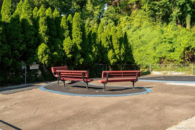a backyard of a house with trees and outdoor seating