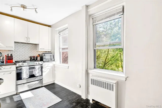 a kitchen with a stove a sink and a window
